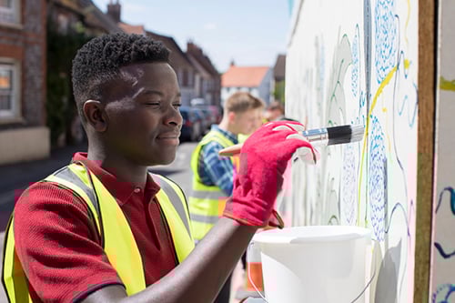Young male painting a mural
