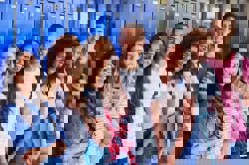 group of high school freshmen leaning against lockers